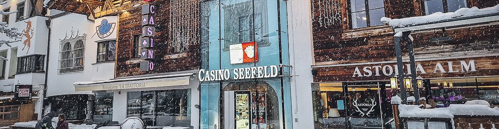 Ein eleganter Pokertisch in einem stilvollen Casino in Seefeld, Österreich, umgeben von Spielkarten, Jetons und einem grünen Filztisch.